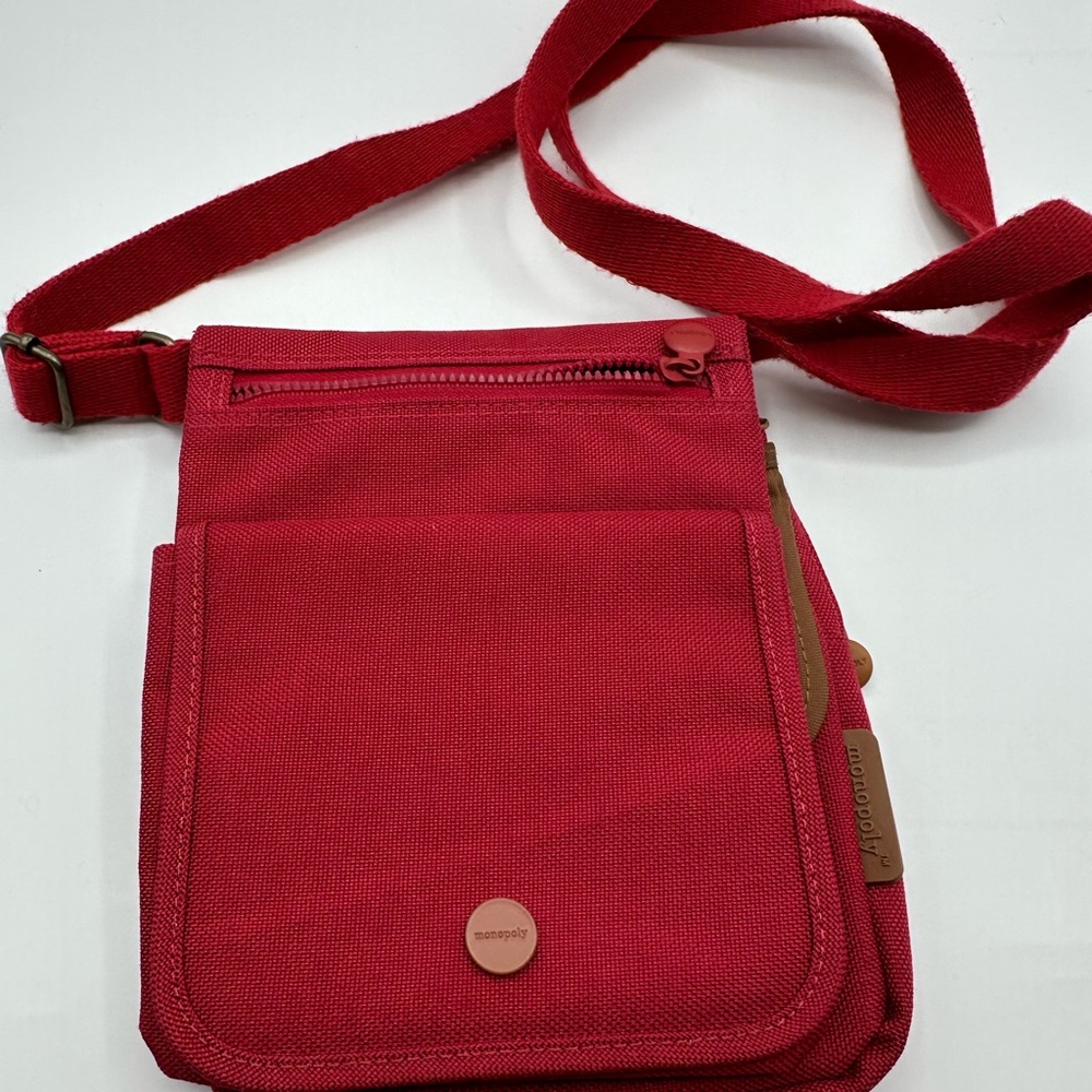Monopoly Brand Red Crossbody Bag with Adjustable Strap and Durable Fabric